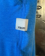 Bright blue pants — Vuori brand patch and seam detail