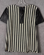 Black and White Geometric Shift Dress with Contrast Faux-Leather Sleeves — back geometric button placket