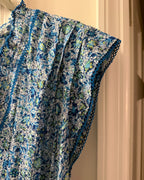 Cap sleeve and blue crochet-style trim detail